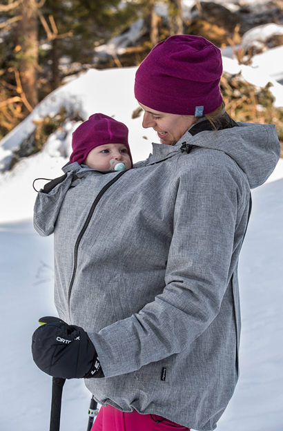 Mother walks with child in the snow
