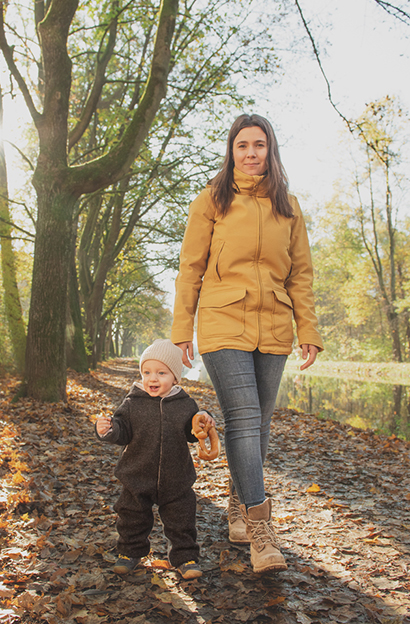 mom walks with child in walk suit