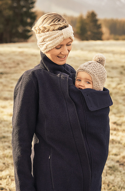 mother wear her baby under the jacket