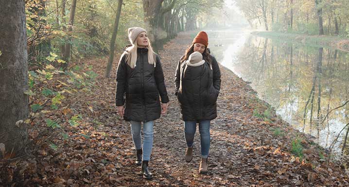 Pregnant women and mother with child take a walk
