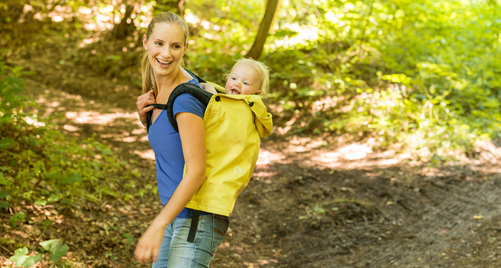 Mom wearing hear child on the back