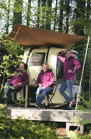 three women in front of a Tiny House